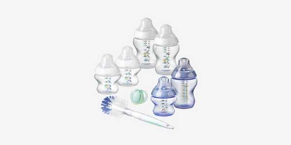A starter set of 6 bottles by Tommee Tippee in blue and white with a bottle brush and a baby soother.